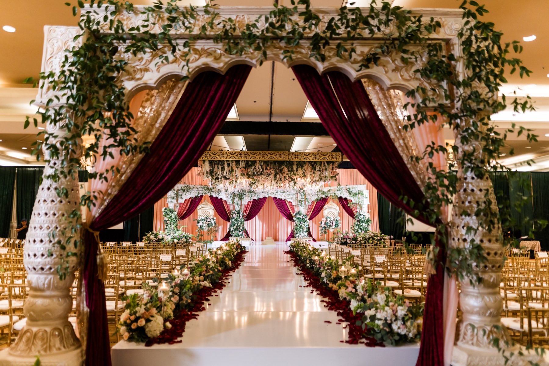 Elegant wedding portrait of couple surrounded by floral arrangements