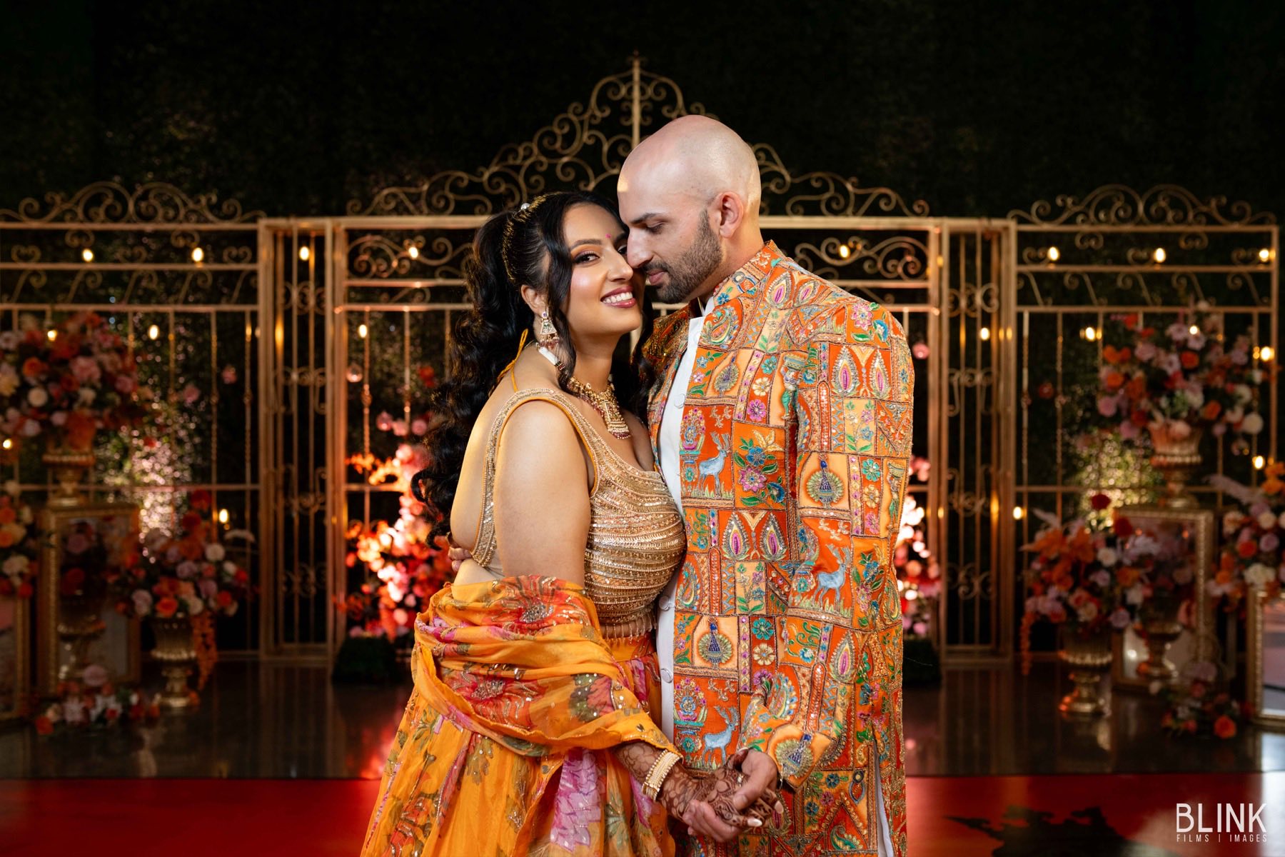 Vibrant sangeet celebration with elaborate stage decor and festive atmosphere